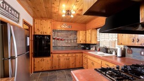 Oven, toaster, spices, dining tables