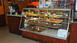A bakery display case with various baked goods.
