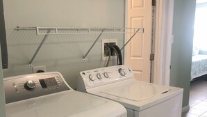 A laundry area with two white washing machines and a drying rack. - Fins Up Unit #1 - On The Bayside - Downtown - Spacious Unit! (Ocean City)