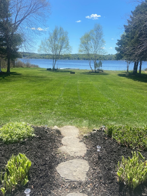 A pathway leading to a lake with a clear sky. - Private Lakefront Log Cabin (Portage Lake)