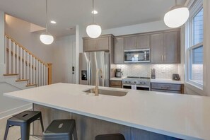 Fridge, microwave, oven, stovetop - Modern East Nashville Townhome with Kings & Queens | Walk to Local Restaurants & Bars | 2 Workspaces, 2-Car Garage, Smart TVs in Every Room | Near Five Points, The Gulch & 10 min to Broadway | 24 Hr Hospitality (Nashville)