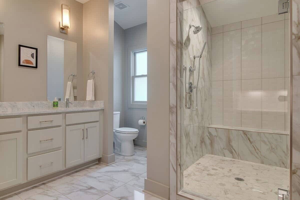 Bathtub, hair dryer, towels, shampoo