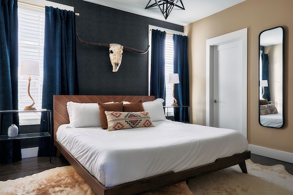 This king size bedroom isn't just a vibe! It has an en suite bathroom, AND the bed is so comfortable!