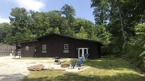 A rustic wooden cabin with a porch, a grill, and outdoor seating. - Hikers Retreat• Handcrafted Cabin in RRG • PET FRIENDLY• Location is Key  (Pine Ridge)