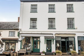 A white building with multiple windows and a green door. - House - Sleeps 6 & paid off site parking available (Minehead)
