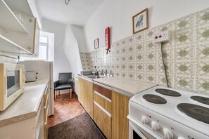 A compact kitchen with a stove, sink, and a microwave. - House - Sleeps 6 & paid off site parking available (Minehead)