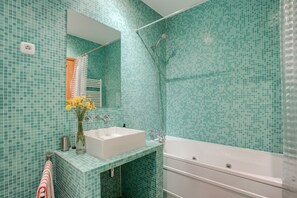 Banheira, secador de cabelo, toalhas de banho 