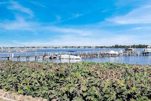 A marina with boats docked, a clear sky, and a distant shoreline. - Bayside Corner Unit, Dog OK, Walk to Turtle Beach (Sarasota)