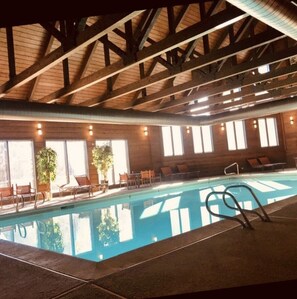 Relax and socialize by the pool, surrounded by lounge chairs and tables.