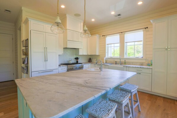 A spacious kitchen with a large island, white cabinetry, and pendant lighting. - Private Pool & Hot Tub; Spacious Roof Deck w/ Views of Ocean;  2 Master Suites; 1 Block to Beach! (Isle of Palms)