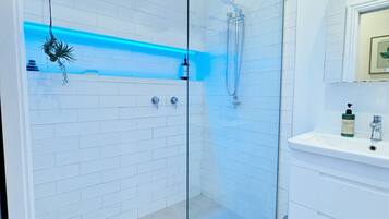 Shower, rainfall showerhead, hair dryer, towels