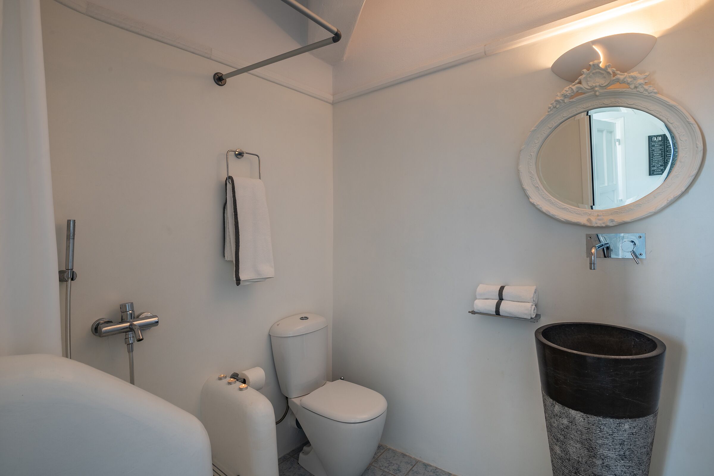 A bathroom with a bathtub, toilet, and sink.