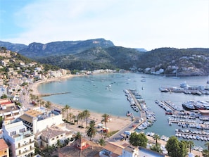 A coastal town with a marina, beach, and residential buildings. - Idyllic, Spacious villa with Sea View,Heatable Pool and garden in Port de Sóller (Sóller)