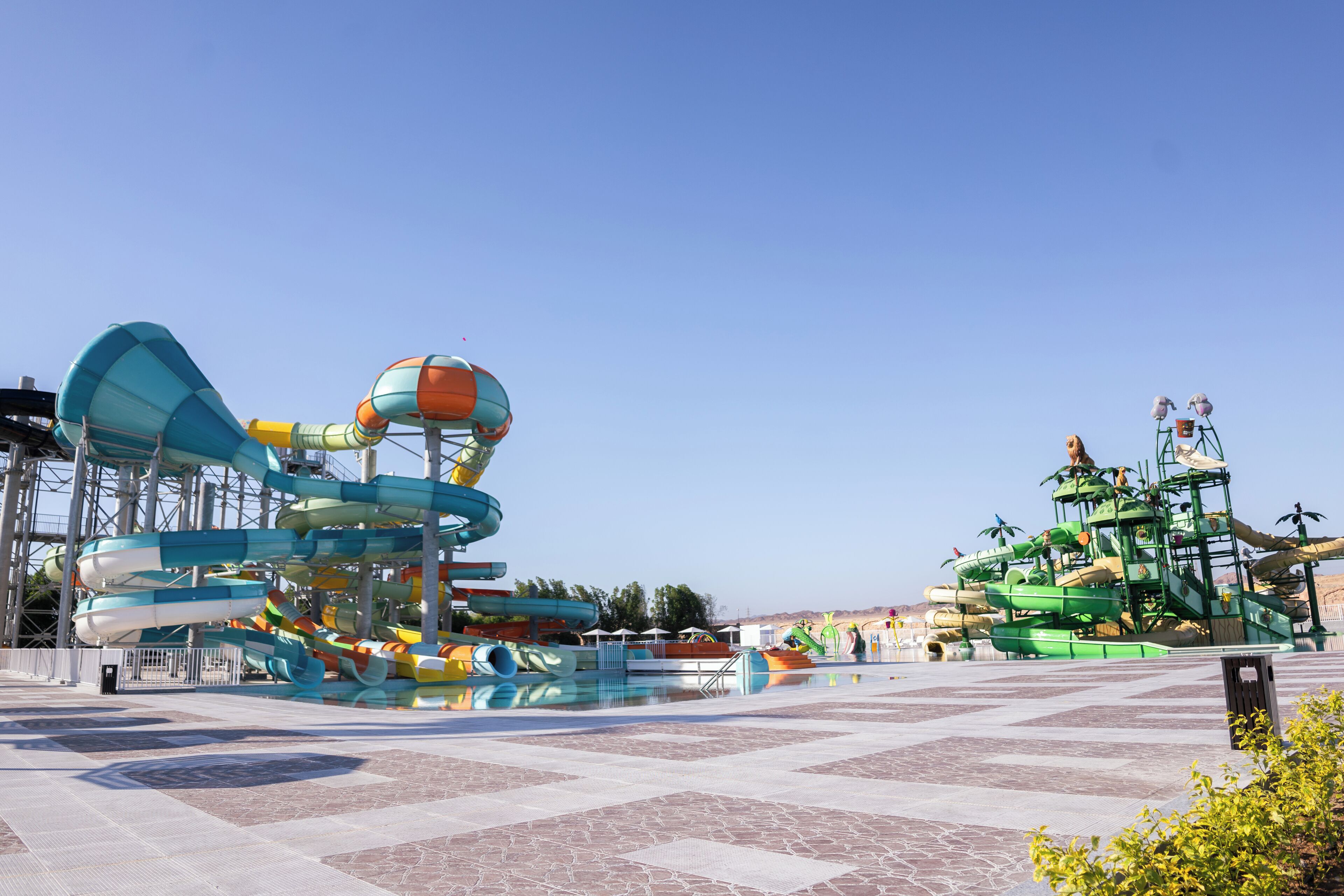 A water park with multiple water slides and a large pool area.