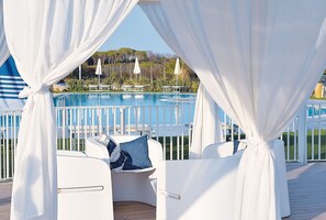 Una piscina al aire libre, sillones reclinables de piscina