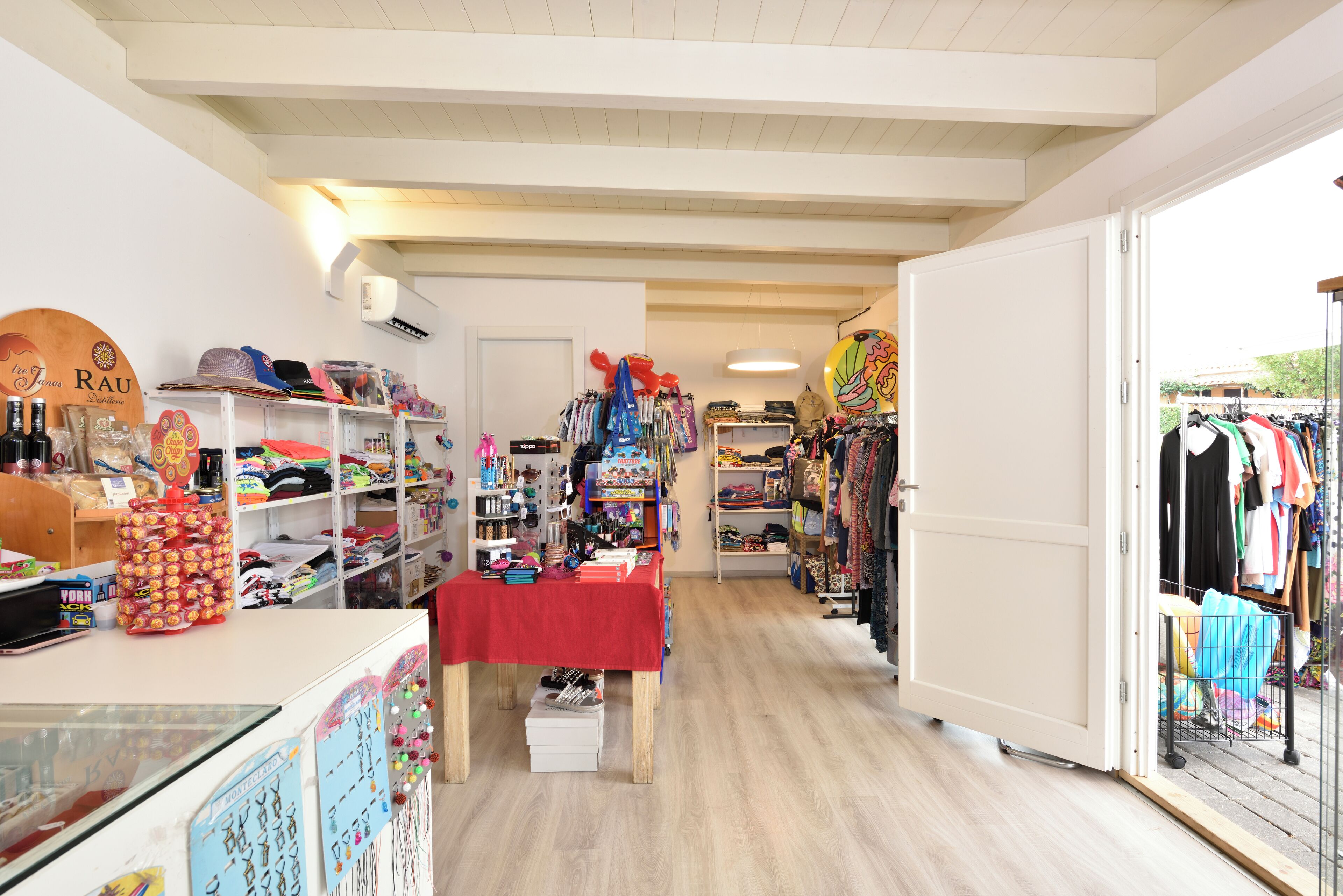A boutique store with shelves of hats, clothing, and accessories.