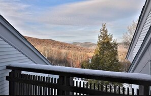 Enjoy breathtaking views of the surrounding landscape from this balcony.