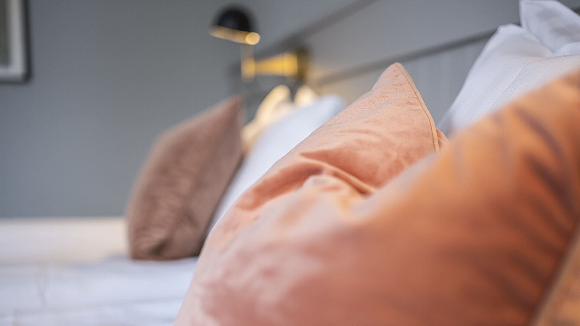 A close-up of a bed with multiple pillows.
