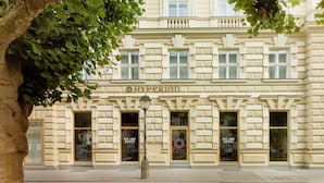 A building with the name "Hyperion" on the facade, featuring large windows and a classical architectural style.
