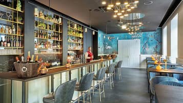 A bar area with a bartender, shelves of liquor, and seating.