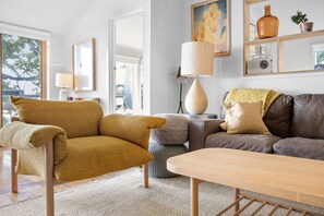 A modern living room with a sofa, armchair, and a coffee table. - Retro Beach Vibes (Lorne)