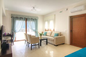 Relax in this stylish living room with a sofa set, dining table, and flat-screen TV.