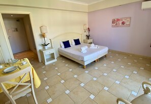 Relax in this serene space with a large bed, bedside table, and comfortable chair.