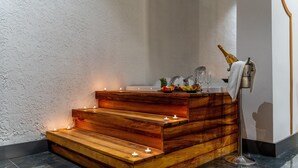 A wooden staircase with candles, a fruit plate, and a champagne bottle in a modern bathroom setting. - Amon Hotel Belek - All Inclusive (Serik)