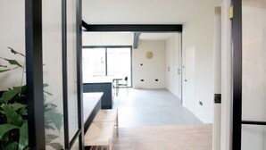 A modern interior with a long hallway, a dining area with a bench, and a view of the outdoors. - Stunning, Brand New 3BR Home - Central Oxford - Pass the Keys (Oxford)