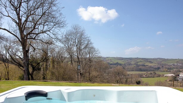 A hot tub with a view of a rural landscape. - 3 bedroom accommodation in Butterleigh, near Tiverton (Butterleigh, near Tiverton)
