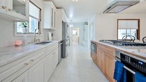 A modern kitchen with white cabinetry, a stainless steel range, and a built-in oven. - Modern Home Near The Battery Truist Park & Marietta Square Steam Shower Sleeps 8 (Marietta)