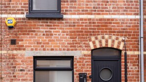 A brick building with a black door and a large window. - Downshire Haven (Holywood)