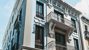 A multi-story building with a classical architectural style, featuring ornate balconies and a symmetrical facade.