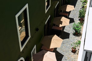 A courtyard with outdoor seating and potted plants. - EL Colonial Hotel Open Bar Adults Only (San Juan)