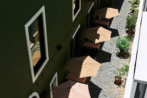 Un patio con mobiliario exterior y plantas en macetas.