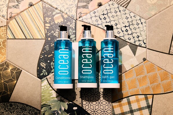 Three bottles of Ocean brand hair care products on a patterned floor.