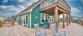 Martinis & Bikinis, a beach front house with toes in the sand drink in the hand.