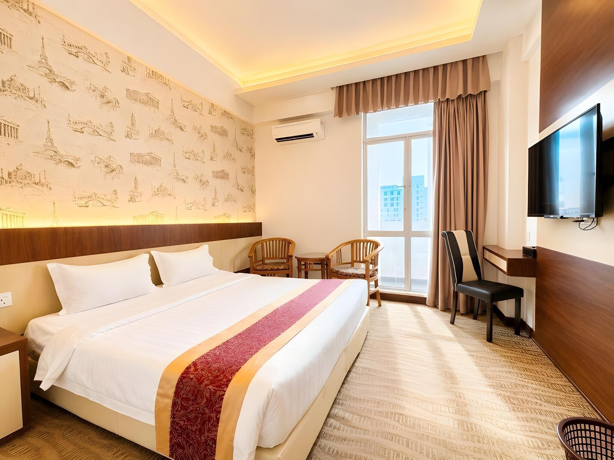 Une chambre d’hôtel avec un grand lit, une télévision, un bureau et une chaise.