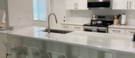 Coffee/tea maker, fridge, microwave, oven