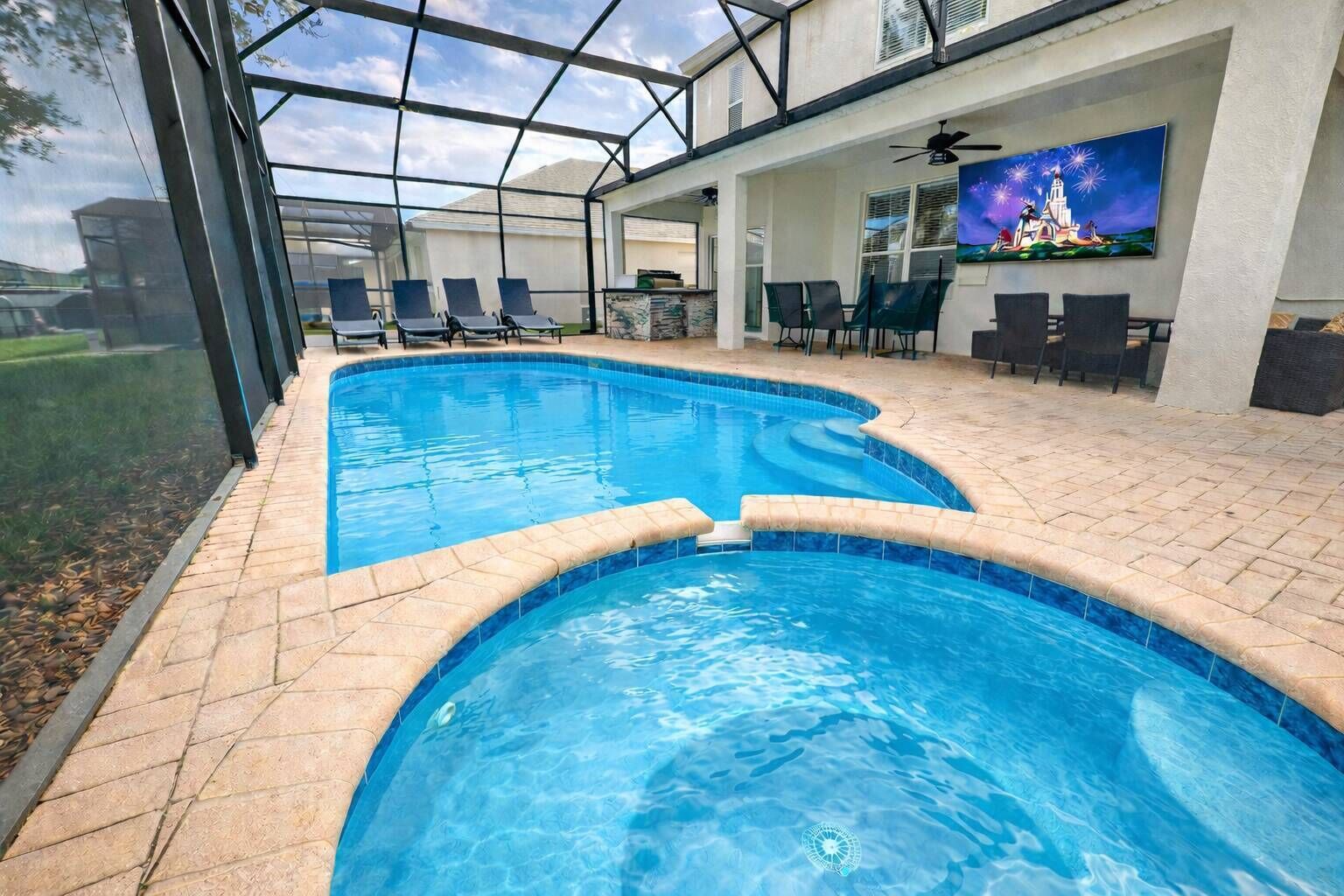 An indoor swimming pool with a glass ceiling, lounge chairs, and a bar area.