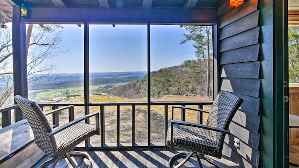 A wooden deck with two wicker chairs and a table, overlooking a scenic valley. - Secluded Ridgetop Hideaway w/ Valley Views! (Menlo)
