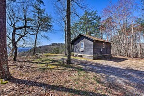 A cabin with a small porch, surrounded by trees and a clear sky. - Secluded Ridgetop Hideaway w/ Valley Views! (Menlo)