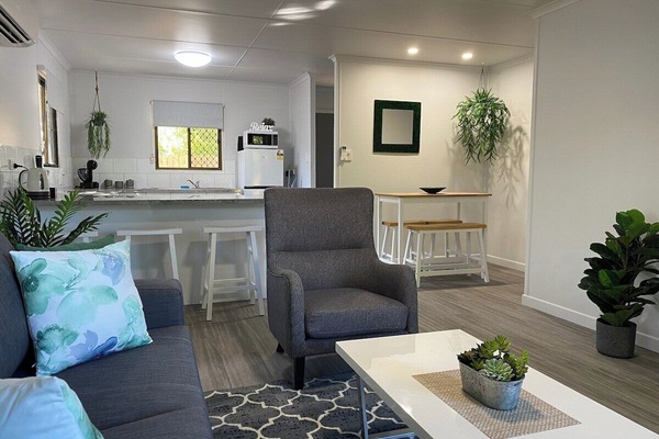 The open-plan living, dining, and kitchen area provides ample space for you to relax and unwind during your stay. It's the perfect setup for enjoying comfort and convenience all in one place.