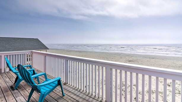 A wooden deck with turquoise chairs overlooking a beach. - Unobstructed Beachfront! Galveston Oasis w/ Decks (Galveston)