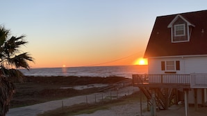 A beachfront house with a deck and a staircase leading to the beach. - Stunning beach views-100 steps to beach-Huge deck (Surfside Beach)