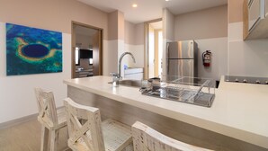 A modern kitchen with a large island, stainless steel appliances, and a minimalist design.