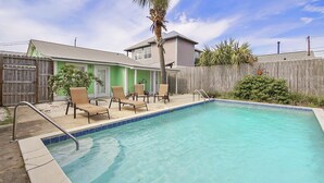 A swimming pool with lounge chairs and a wooden fence. - {Laguna Shores} 1 Block 2 Beach + Pool-Dogs OK (Panama City Beach)