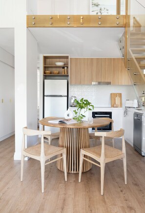 Eine moderne Küche mit einer zentralen Kochinsel, Holzschränken und Edelstahlgeräten.