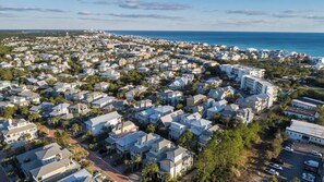 An aerial view of a coastal residential area with houses, roads, and a beach in the background. - Spacious 30A Home Steps to Beach With King Suites and Loft Space (Panama City Beach)