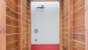 A room with a wooden interior, a white door with a lock, and a red lower section. - Spacious 30A Home Steps to Beach With King Suites and Loft Space (Panama City Beach)